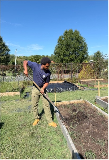 Lean White working in a garden in Mecklenburg County.