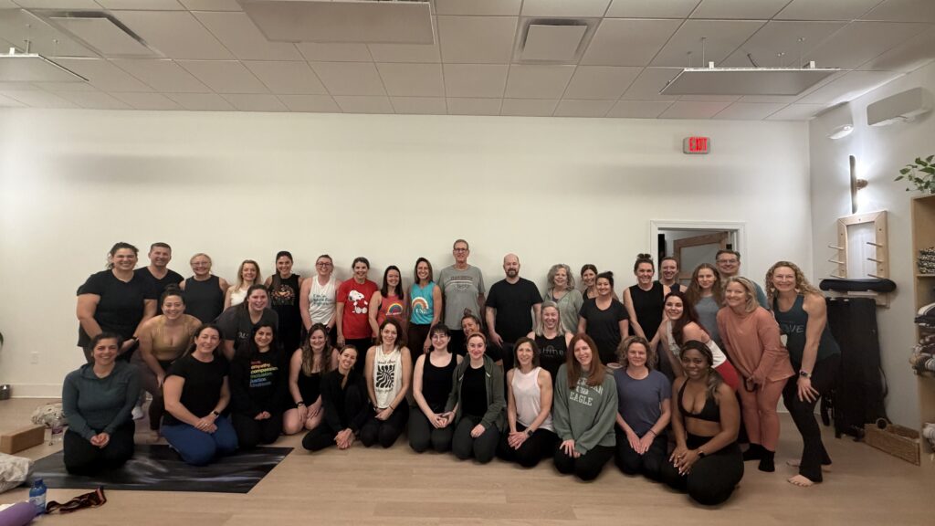 Photo of participants at iShine Yoga & Wellness in Huntersville during a fundraiser for Carolina Migrant Network - “Rooted in Solidarity: Breath, Movement and Community Care. Photo by Penelope Goldstein, Queens University News Service