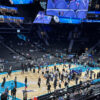 View of basketball court, players and fans at Spectrum Center in Charlotte.