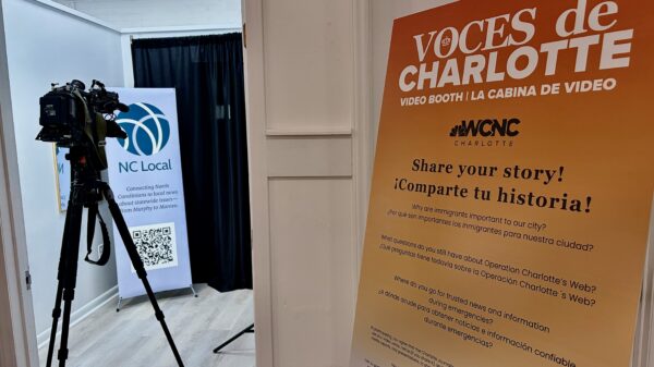A poster and video camera at the entrance to the Voces de Charlotte event on Oct. 1.