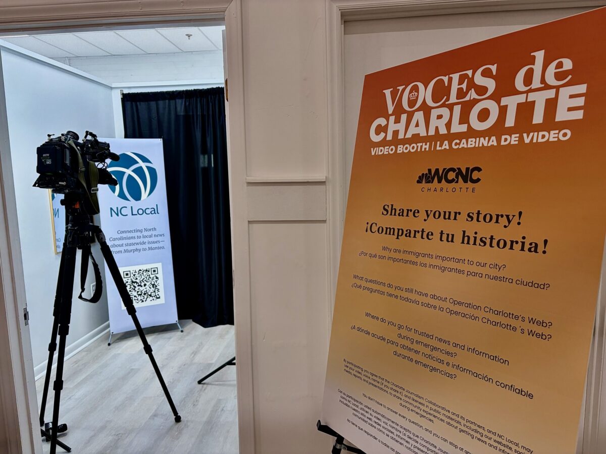 A poster and video camera at the entrance to the Voces de Charlotte event on Oct. 1.