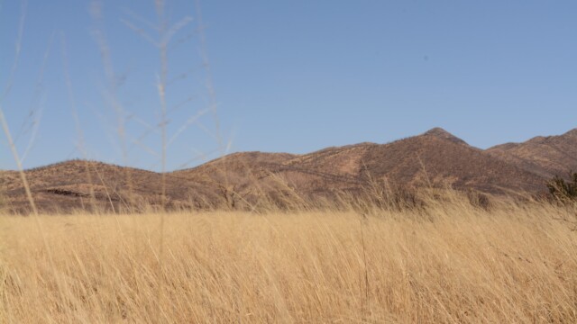 Agua Prieta lies in the flat, dry, valley landscape of the Sonoran Desert surrounded by the distant Sierra San Luis Mountain range.